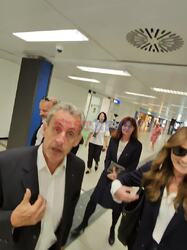 *EXCLUSIVE* WEB MUST CALL FOR PRICING  - Former French president Nicolas Sarkozy scolds the photojournalist who photographed him and his wife Carla Bruni at Milan airport Carla Bruni jokes and warns the photographer by saying "be careful he hits you"