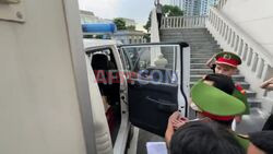 Vietnamese tycoon leaves court after receiving 21-year jail sentence - AFP