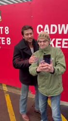 'It Ends with Us' star Brandon Sklenar is seen taking pictures with fans as he makes his way to the Wrexham stadium before the game