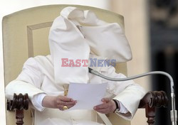 Pope mantle is blown by the wind as he reads his message during the weekly general audience