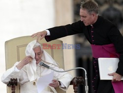 Pope mantle is blown by the wind as he reads his message during the weekly general audience