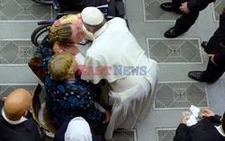 Pope Francis recives a caress from a disabled man 