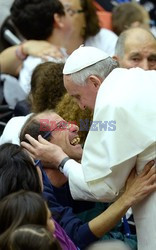 Pope Francis recives a caress from a disabled man 